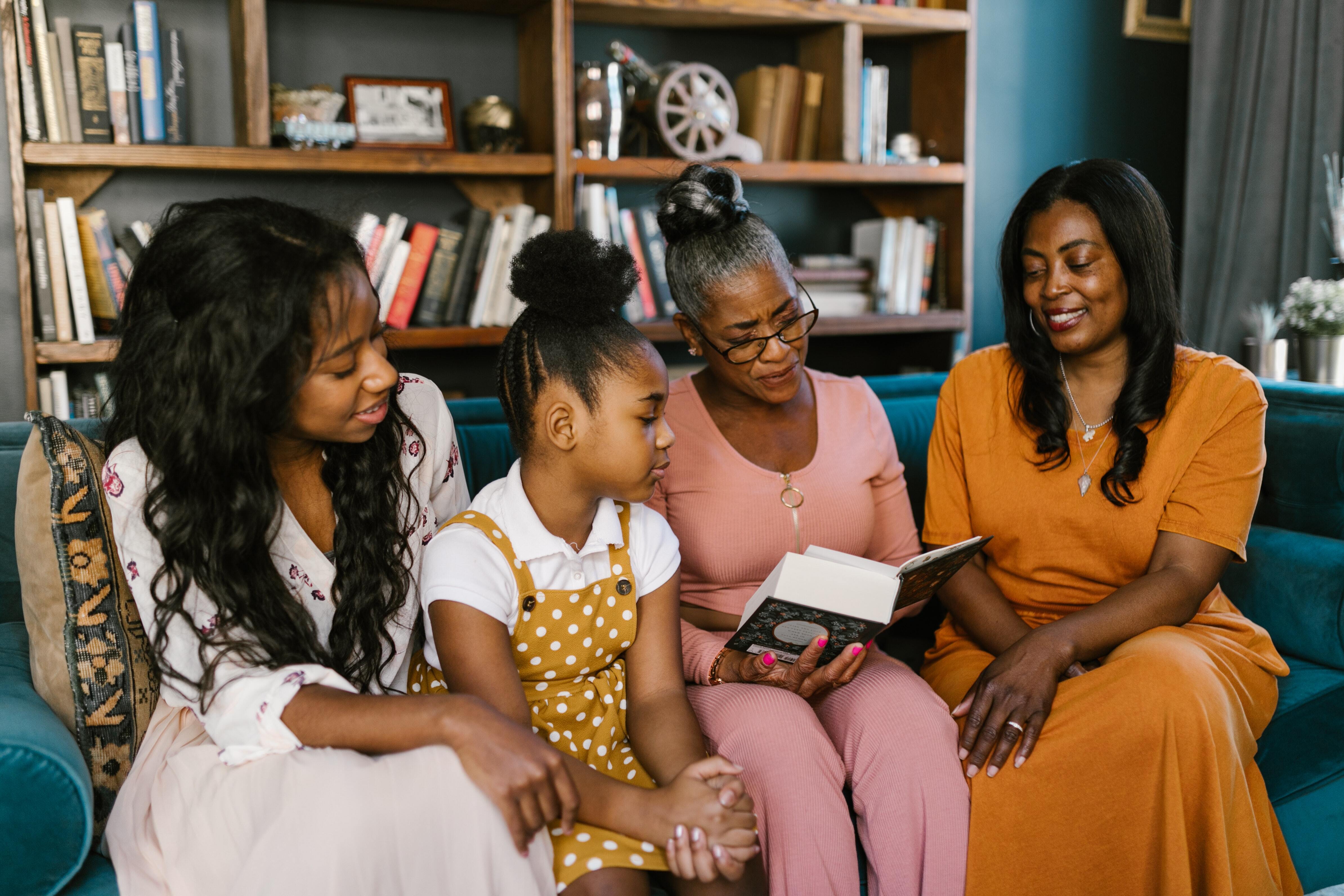 An multigenerational group of black women reading together